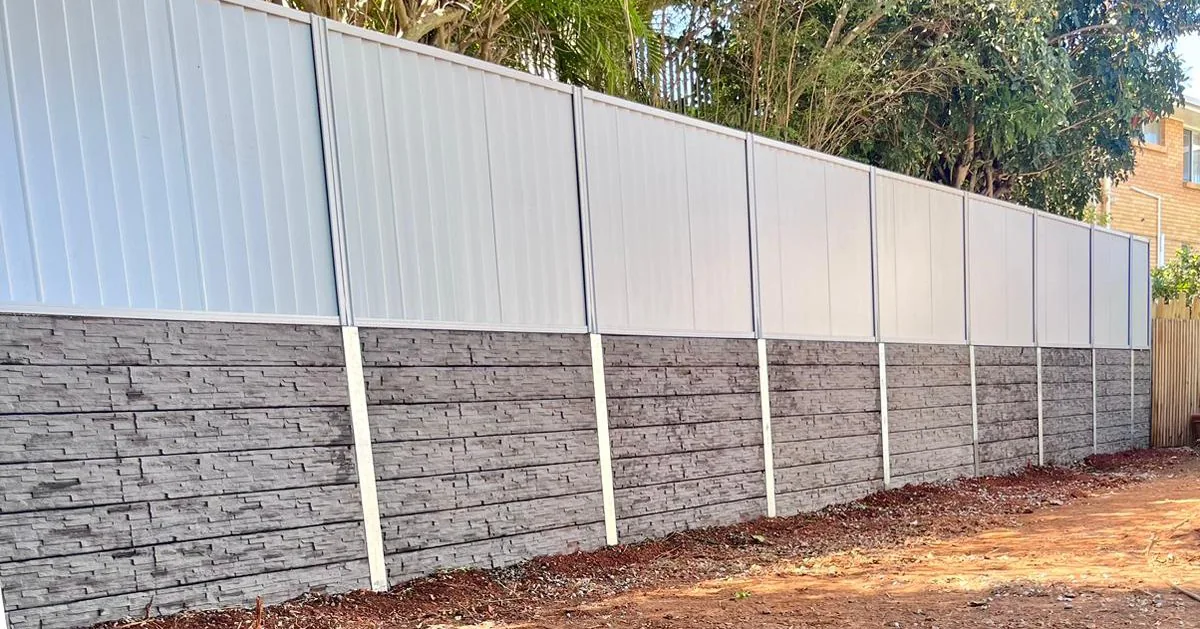 Colorbond fencing installed above a concrete sleeper retaining wall