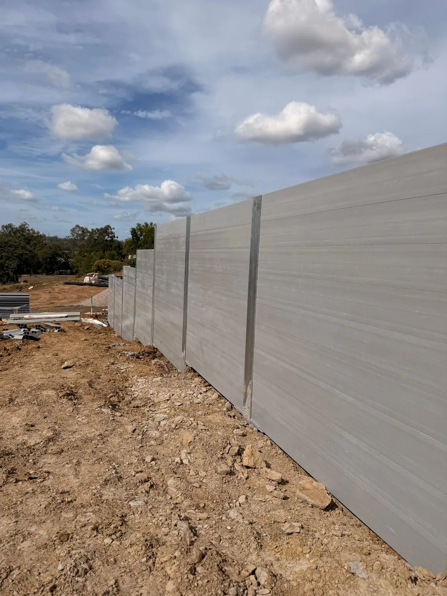 Grey concrete sleeper retaining wall on a commercial construction site