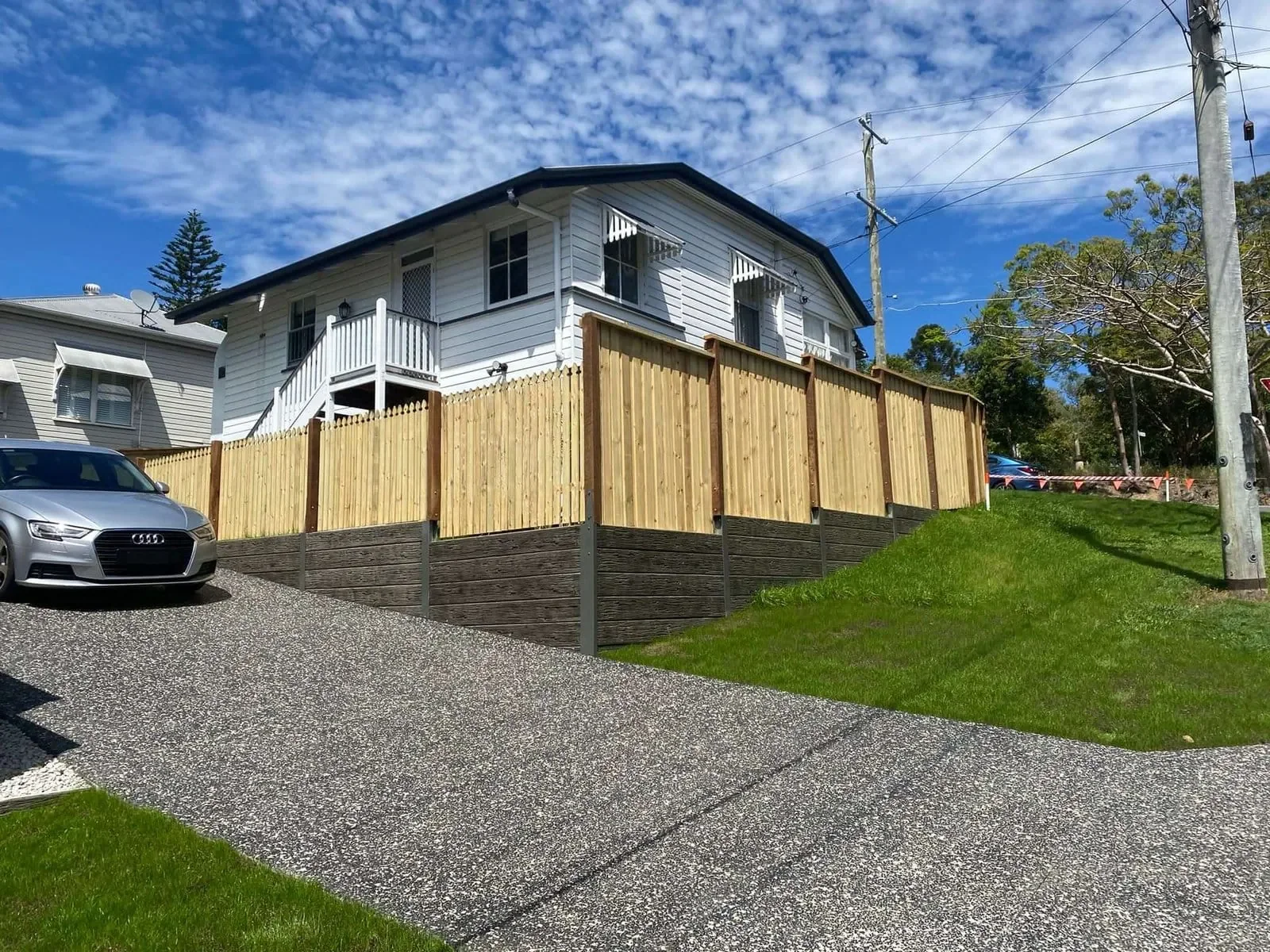 Timber fencing installed above a concrete sleeper retaining wall